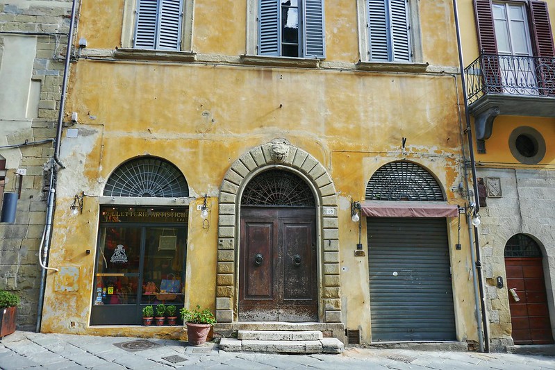 Arches and doorways of a yellow building in Arezzo Italy
