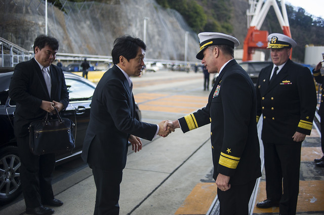 Japan Minister of Defense meets and shakes hands with commander, Naval Forces Japan