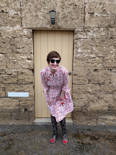 A woman in a floral print shirtdress.