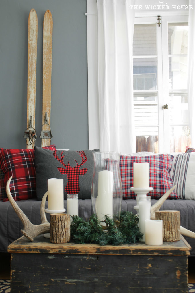 use Plaid Reindeer Pillows, Candle, Evergreen Coffee Table Decorating to Decorate for Christmas in Small Spaces
