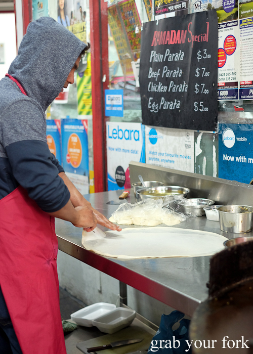 Stretching out parata dough at the Ramadan food festival in Lakemba Sydney