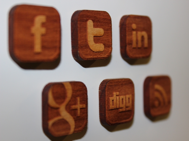 social media symbols on wooden refrigerator magnets