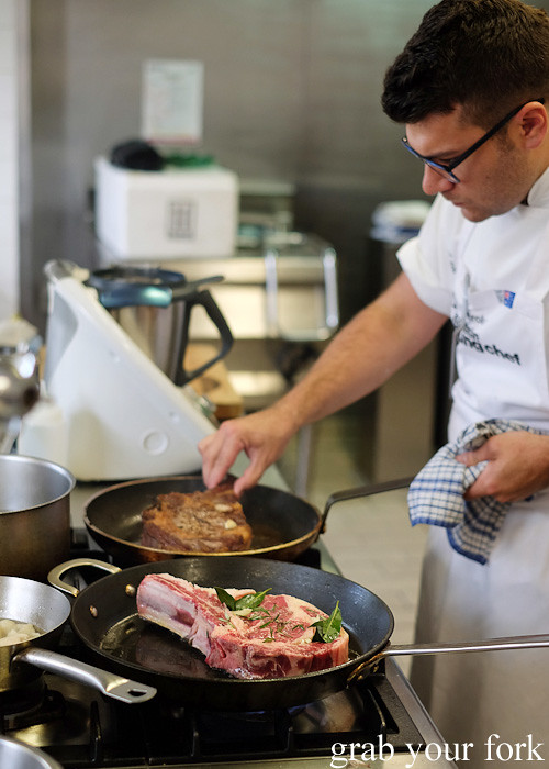 Troy Crisante from Bennelong Restaurant, Sydney cooking ribeye steaks at the Appetite for Excellence Young Chef of the Year 2016 final cook off