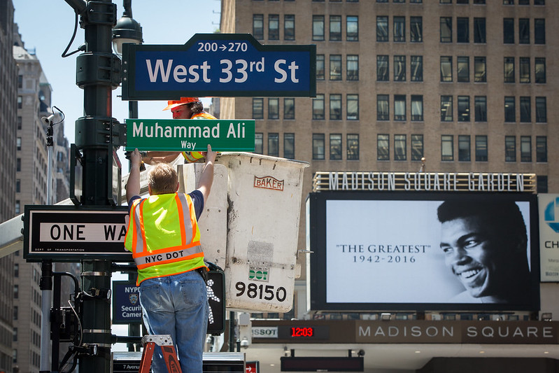 Department of Transportation employees install a street sign renaming West 33rd Street between Eighth and Seventh Avenues, "Muhammad Ali Way"