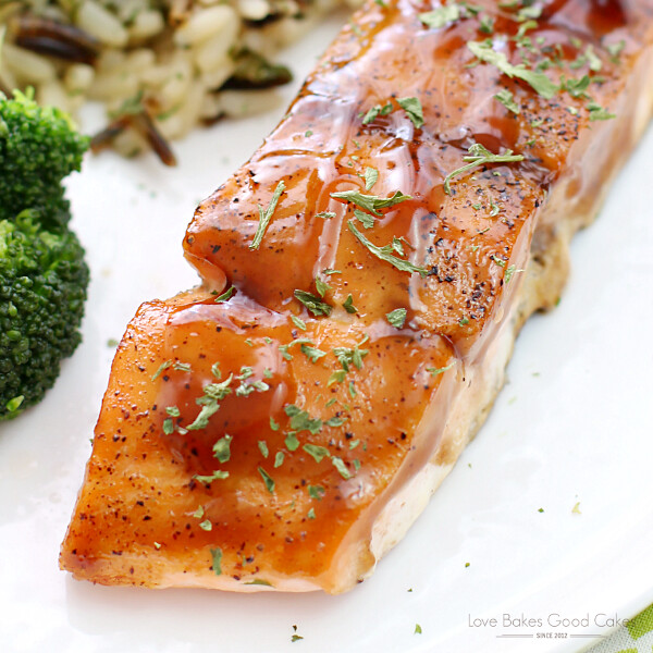 Dr Pepper Glazed Salmon with rice and broccoli on a white plate close up.