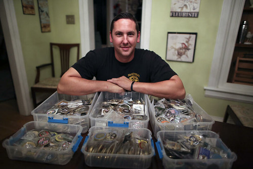 Police Officer Jason Walters with challenge coin collection