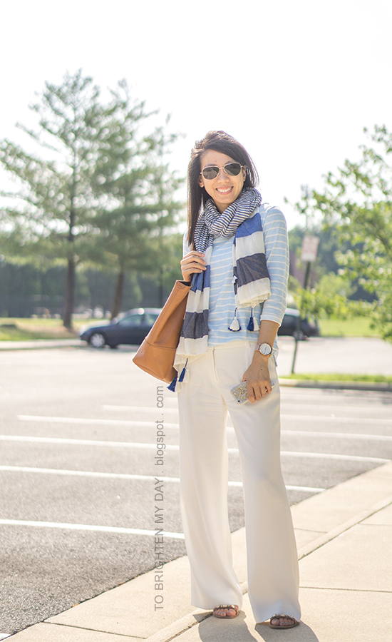 blue striped scarf with pom poms, blue striped top, white wide-legged trousers, oversized watch